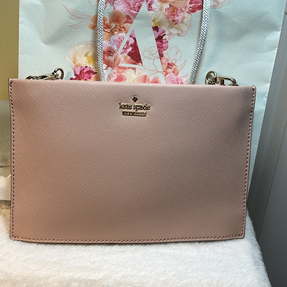 Kate Spade Bag gold name on outside of bag, pink leather, gray and white lining